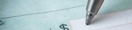 image of pen writing on a check